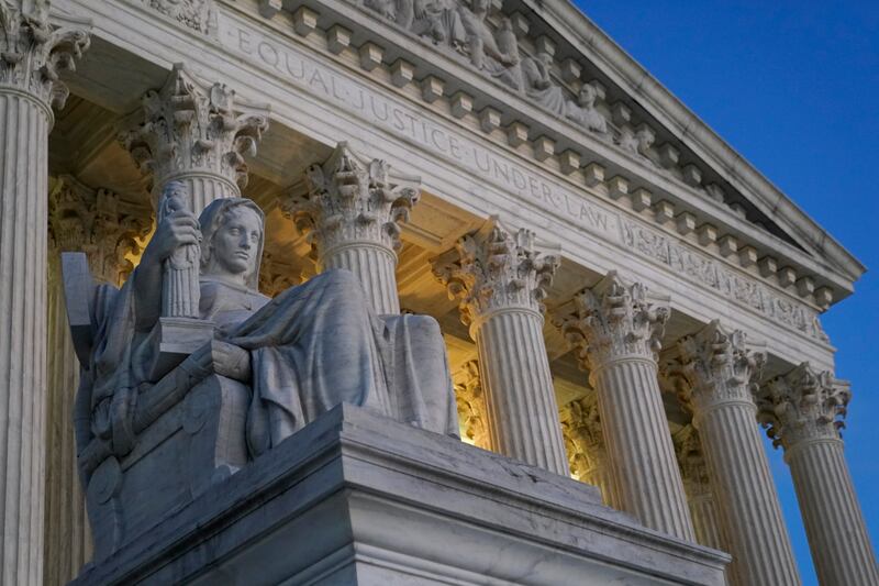Light illuminates part of the Supreme Court building on Capitol Hill in Washington.
