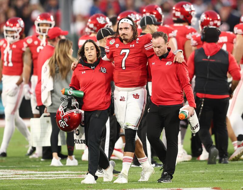 Utah Utes QB Cameron Rising (7) is helped off the field after getting injured on a run as Utah and Penn State play in the Rose Bowl in Pasadena, California, on Monday, Jan. 2, 2023. Penn State won 35-21.