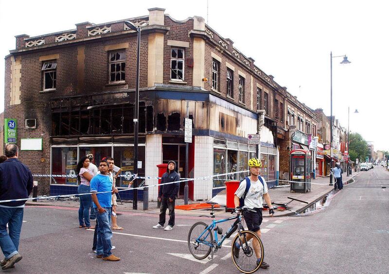 A burned out building, which was destroyed during rioting and looting on the Tottenham High Road in north London over the weekend , is seen Monday Aug. 8 2011. Residents surveyed shattered streets and arrested more suspects Monday after riots and lootin