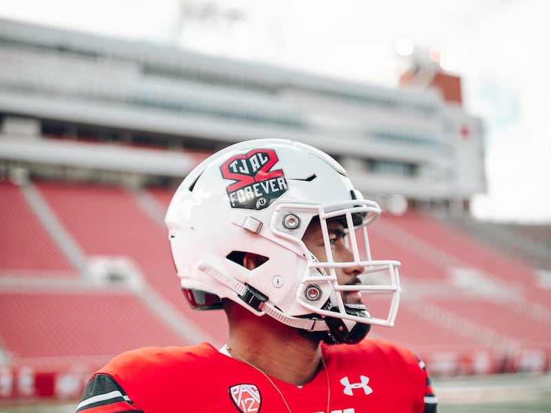 Utah football player Nephi Sewell wears a white helmet with “22 forever logo” and a red jersey