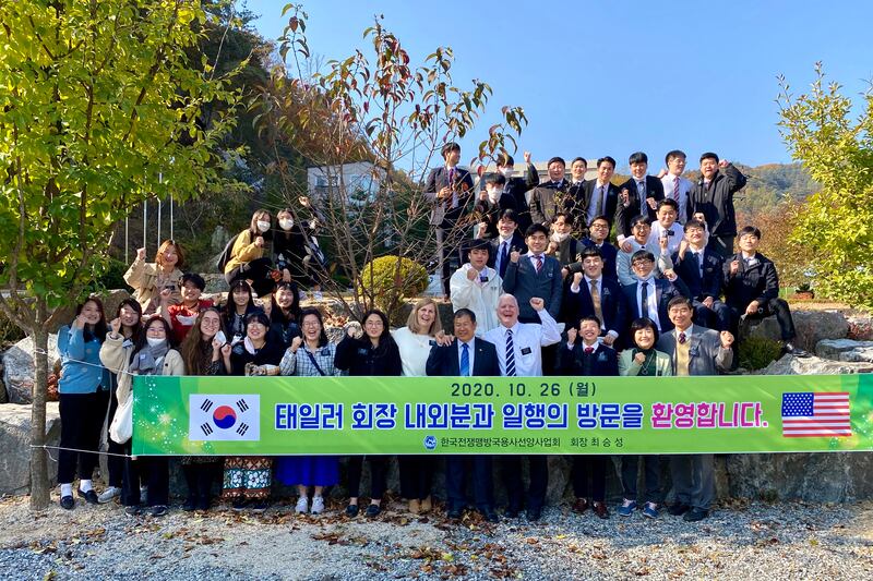 Choi Seung Sung, founder and director of the memorial park at Gapyeong, South Korea, poses with Latter-day Saint missionaries.