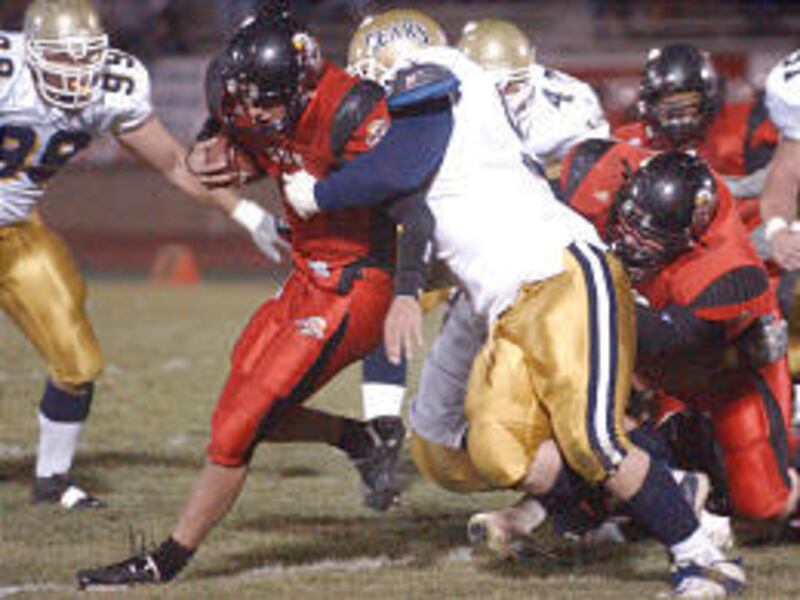 Southern Utah quarterback Casey Reher, center, is brought down by Northern Colorado defensive lineman Jared Wallen in a game earlier this season.