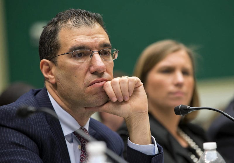 FILE - In this Oct. 24, 2013, file photo, Andrew Slavitt, group executive vice president for Optum/QSSI, left, and Lynn Spellecy, corporate counsel for Equifax Workforce Solutions, listen to questioning during a House Energy and Commerce Committee hearing