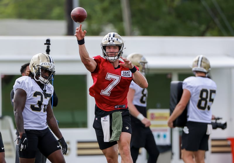 New Orleans Saints quarterback Taysom Hill throws a pass during NFL football training camp.
