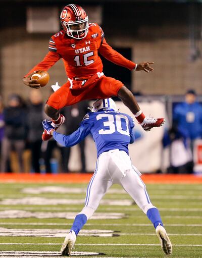 Utah quarterback Jason Shelley (15) huddles BYU defensive back Keenan Ellis (30) in the first half during an NCAA college football game Saturday Nov. 24, 2018, in Salt Lake City. (AP Photo/Rick Bowmer)