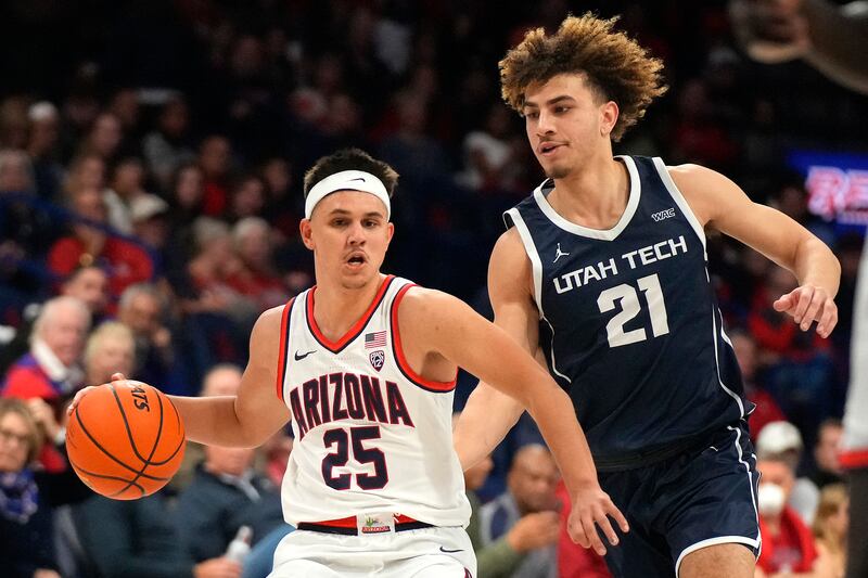 Arizona guard Kerr Kriisa (wearing white) shields the ball from Utah Tech guard Isaiah Pope