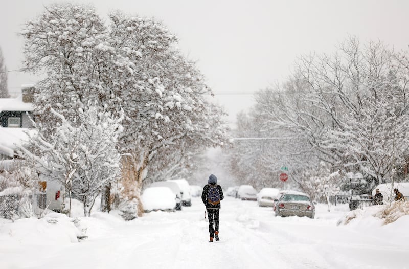 A man walks after a snowstorm in Salt Lake City.