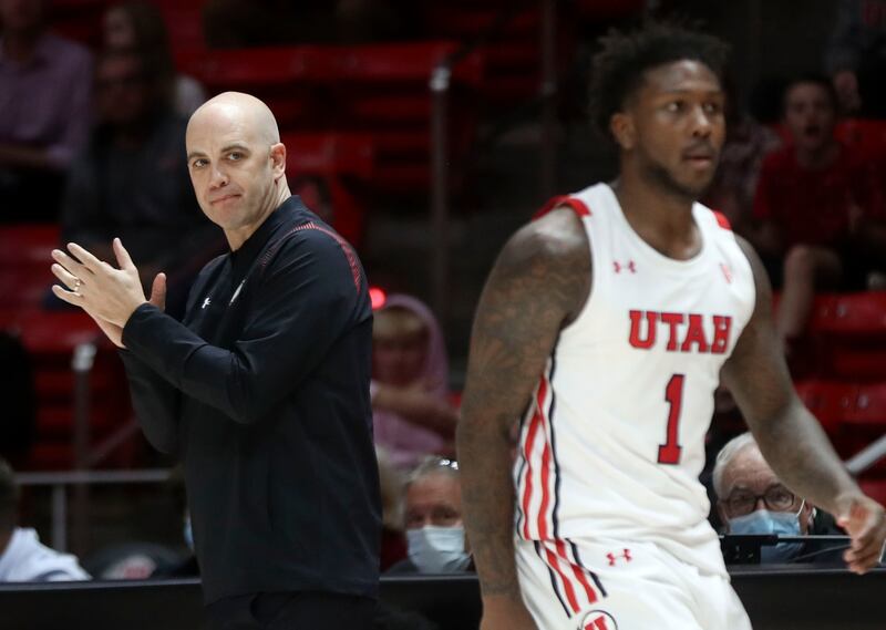 Utah Utes basketball coach Craig Smith claps during the game against Westminster.