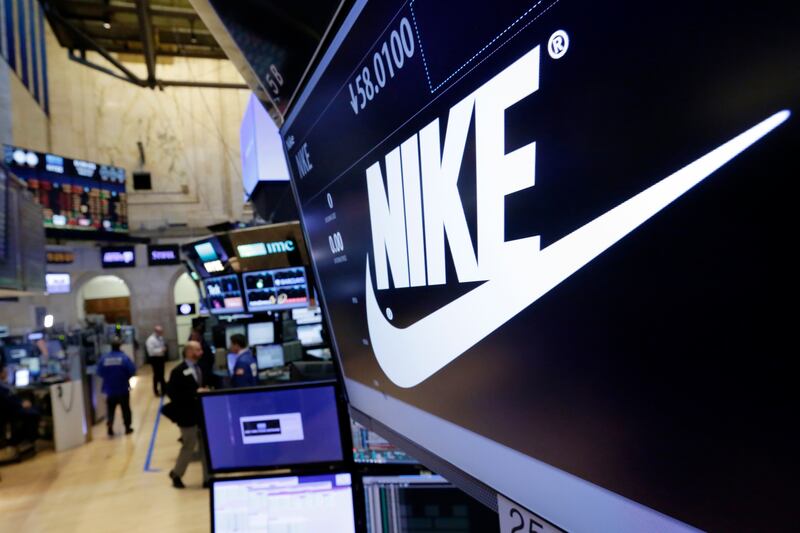 In this March 22, 2017, file photo, the Nike logo appears above the post where it trades on the floor of the New York Stock Exchange.