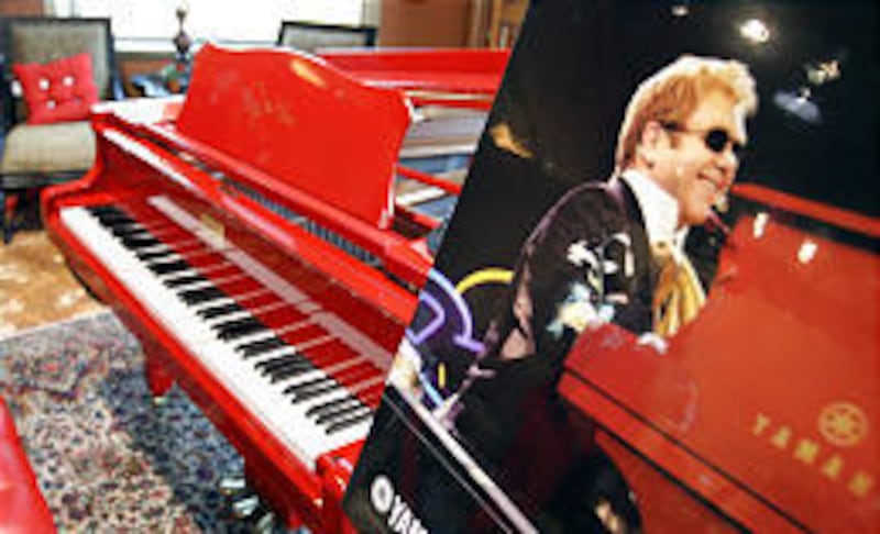 A red piano autographed by Elton John was on display at Steve Peterson Interiors Unlimited in Orem Friday. A local family bought the piano, which has a special laser-disc recording mechanism.