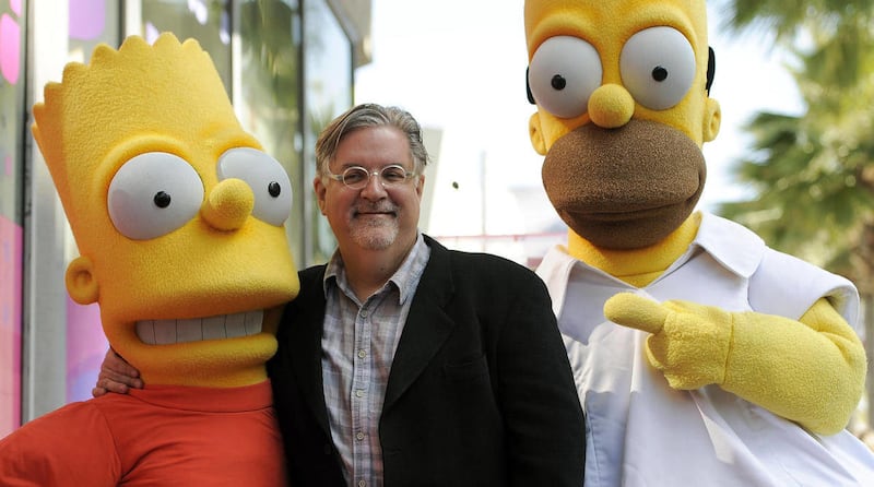 FILE - In this Feb. 14, 2012 file photo, Matt Groening, creator of the animated series "The Simpsons," poses with his character creations Bart Simpson, left, and Homer Simpson after he received a star on the Hollywood Walk of Fame in Los Angeles. One of t