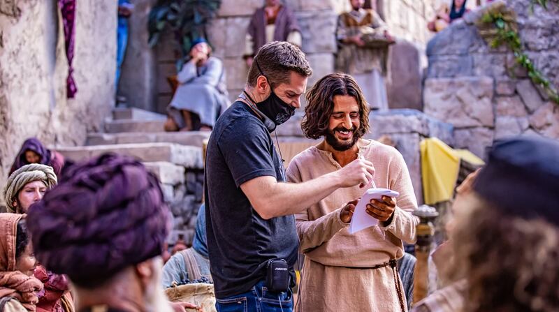Director Dallas Jenkins, left, speaks with actor Jonathan Roumie, who portrays Jesus Christ, on the set of “The Chosen.”