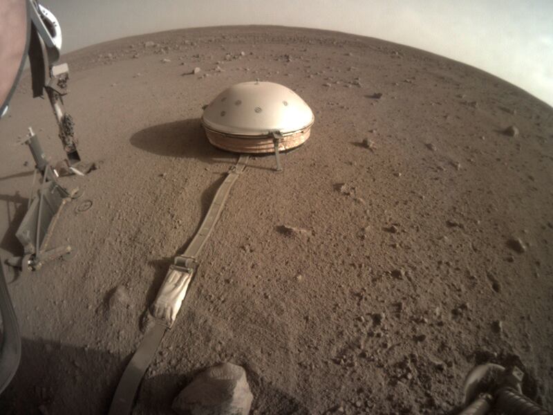 This Feb. 18, 2020 photo made available by NASA shows the InSight lander’s dome-covered seismometer, known as SEIS, on Mars. On Monday, Feb. 24, 2020, scientists reported that the spacecraft has detected hundreds of quakes and even aftershocks that are regularly jolting the red planet.