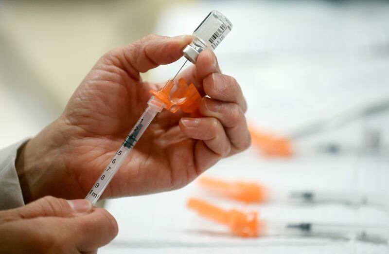 A Salt Lake County Health Department employee prepares Pfizer COVID-19 booster shots in Taylorsville on Nov. 9, 2022.