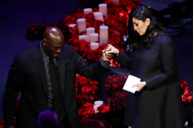Vanessa Bryant is helped off the stage by former NBA player Michael Jordan after speaking during a celebration of life for her husband Kobe Bryant and daughter Gianna Monday, Feb. 24, 2020, in Los Angeles. (AP Photo/Marcio Jose Sanchez)