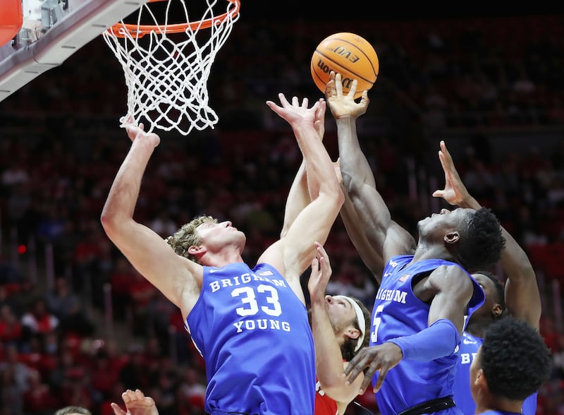 BYU forwards Caleb Lohner (33) and Gideon George (5) battle for a rebound against the Utes in Salt Lake City, Nov. 27, 2021.