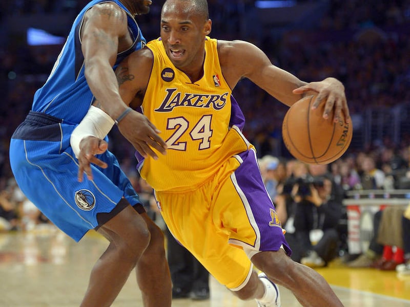 Los Angeles Lakers guard Kobe Bryant, right, drives past Dallas Mavericks guard Mike James during the first half of their NBA basketball game, Tuesday, April 2, 2013, in Los Angeles. (AP Photo/Mark J. Terrill)