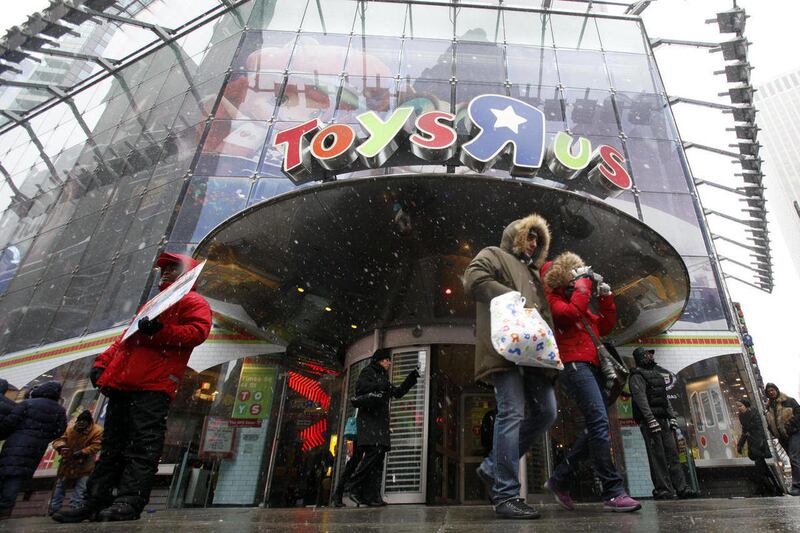 Shoppers leave the Toys R Us store in New York’s Times Square, Sunday, Dec. 26, 2010.