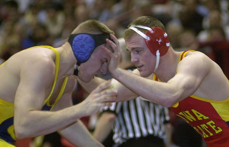 Iowa State's Cael Sanderson, right, wrestles Clarion's Eric Mausser during the first round of the NCAA wrestling tournament in Albany, N.Y. Thursday, March 21, 2002. Sanderson pinned Mausser to remain unbeaten in his college career. (AP Photo/Tim Roske)
