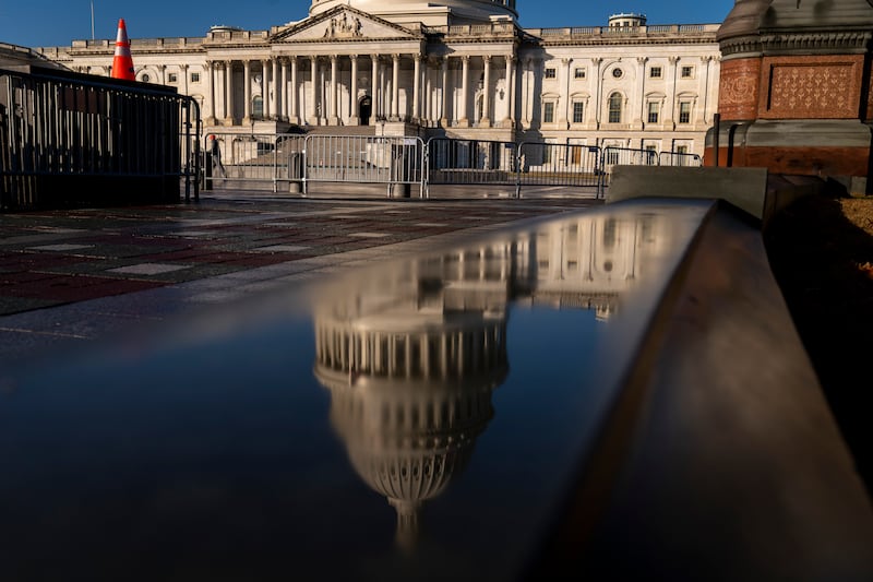 The dome of the U.S. Capitol is visible in a reflection on Capitol Hill in Washington, Monday, Jan. 23, 2023.