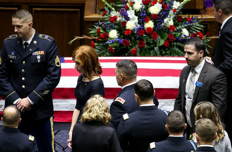 Jennie Taylor, wife of Maj. Brent Taylor, walks past his flag-draped casket before his funeral at the Dee Events Center in Ogden on Saturday, Nov. 17, 2018.