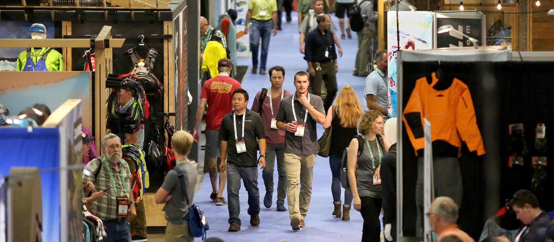 People walk through the Outdoor Retailer show at the Salt Palace Convention Center in Salt Lake City on Friday, July 28, 2017.