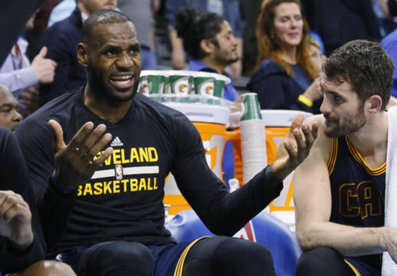 Cleveland Cavaliers forward LeBron James, left, talks with teammate Kevin Love, right, on the bench in the final minute of the team's NBA basketball game against the Oklahoma City Thunder in Oklahoma City, Thursday, Feb. 9, 2017. Oklahoma City won 118-109
