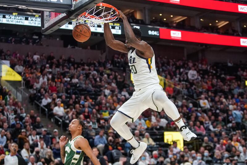 Utah Jazz center Udoka Azubuike, wearing white, goes for a dunk during preseason game against Milwaukee