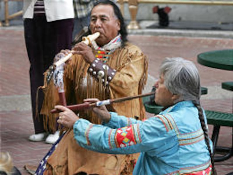 James "Flaming Eagle" Mooney, left, and Gary Tom hold a peace pipe ceremony on Exchange Place.