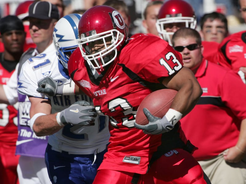 Quinton Ganther breaks a tackle from Mark Carlson of Air Force.