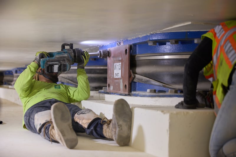 Crews remove bolts from one of the 98 base isolators located 20 feet below the Salt Lake Temple in Salt Lake City on Thursday, June 25, 2026.