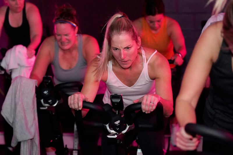 Deb Figulski participates in a spin class at Fuel Training Studio, Jan. 19, 2023, in Newburyport, Mass.