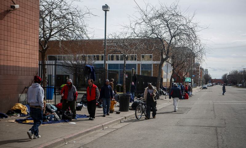 FILE - Homeless people in Salt Lake City wait outside Catholic Community Services at 200 S. 500 West next to the Road Home, called "the block" on Wednesday, March 8, 2017.