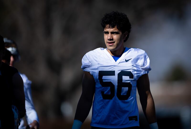 BYU defensive end Logan Fano walks off the field after practice.