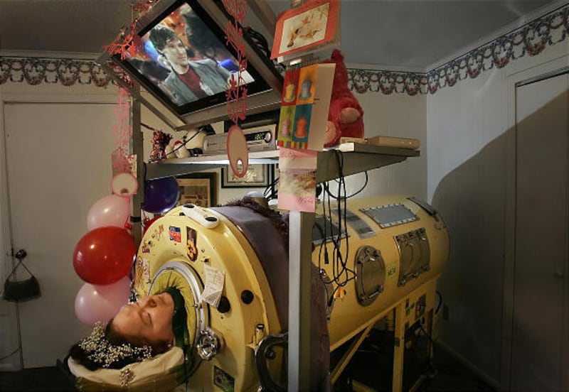 Dianne Odell watches her favorite soap opera in her iron lung at her home in Jackson, Tenn. She died Wednesday at 61.