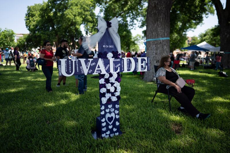 People are pictured at a memorial site in Uvalde, Texas.