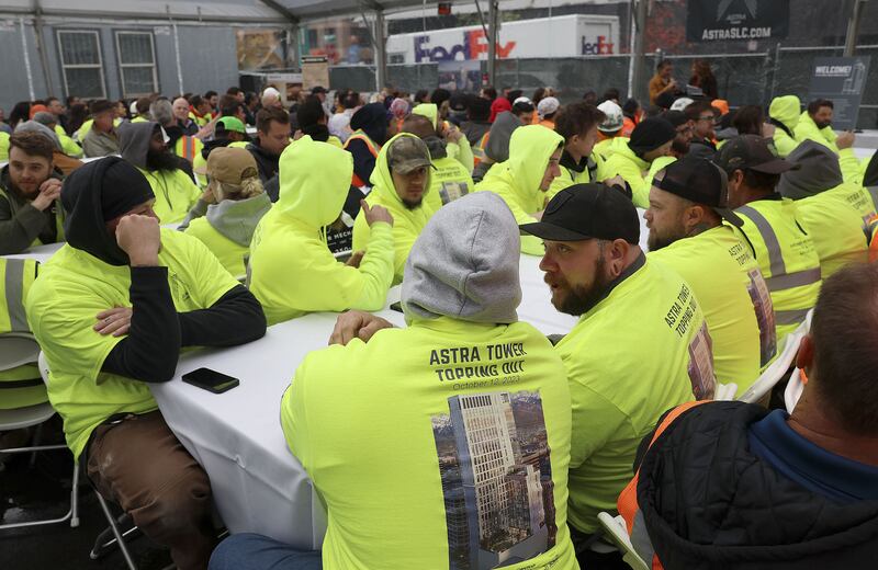 Construction workers attend a beam placement ceremony at Astra Tower in Salt Lake City on Thursday. When finished, the 40-story Astra Tower in the downtown area will be Utah’s tallest high-rise at 450 feet.