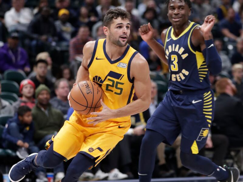 Utah Jazz guard Raul Neto (25) drives past Indiana Pacers guard Aaron Holiday (3) during the second half of an NBA basketball game in Indianapolis, Monday, Nov. 19, 2018. The Pacers defeated the Jazz 121-94. (AP Photo/Michael Conroy)