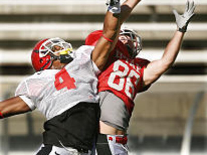 Converted cornerback Sean Smith, left, battles Freddie Brown for a pass.
