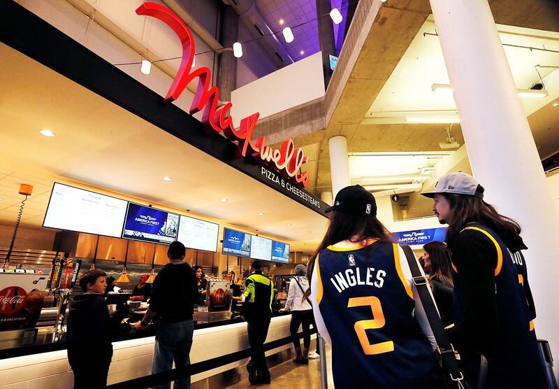 Sarah and Dom Manricks, at right, line up for food at Maxwell's before a Utah Jazz game at Vivint Arena in Salt Lake City on Saturday, Dec. 23, 2017.