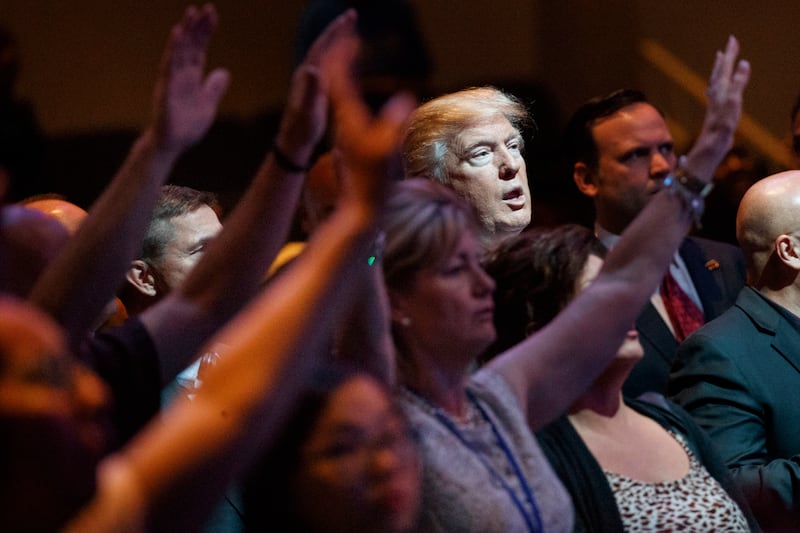 In this Oct. 30, 2016, file photo, Republican presidential candidate Donald Trump stands during a service at the International Church of Las Vegas in Las Vegas. President Trump’s pledge to scrap limits on church political activity could have sweeping effe