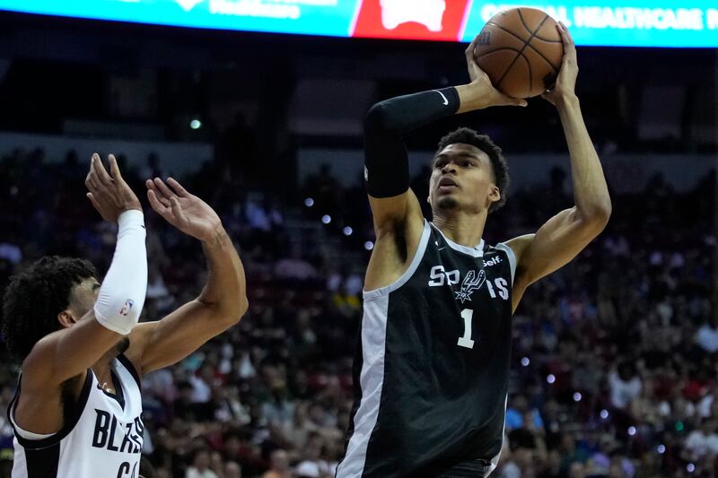 San Antonio Spurs’ Victor Wembanyama shoots over Portland Trail Blazers’ Justin Minaya during NBA summer league play.