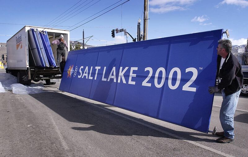 Workers load giant signs on to a truck in Olympic Square in Salt Lake City the day after the closing ceremony of the Salt Lake 2002 Winter Olympics on Monday, Feb. 25, 2002.