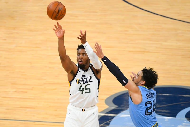 Utah Jazz guard Donovan Mitchell shoots as Memphis Grizzlies forward Dillon Brooks (24) defends Game 3 of their playoff series.