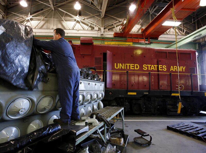 Cody Allen uncovers an engine that will go in an Army locomotive at the Defense Generator & Rail Center at HAFB.