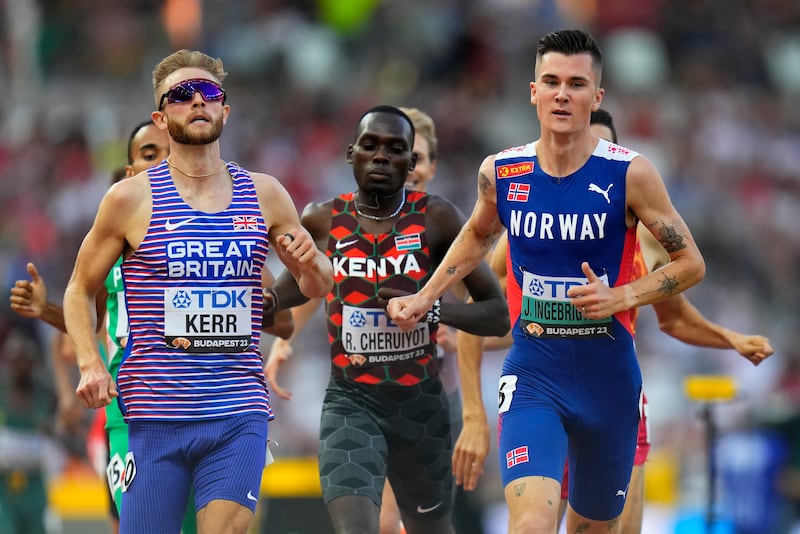 Jakob Ingebrigtsen, of Norway, right, and Josh Kerr, of Great Britain race to the line in a men's 1500-meters heat during the World Athletics Championships in Budapest, Hungary, Saturday, Aug. 19, 2023.