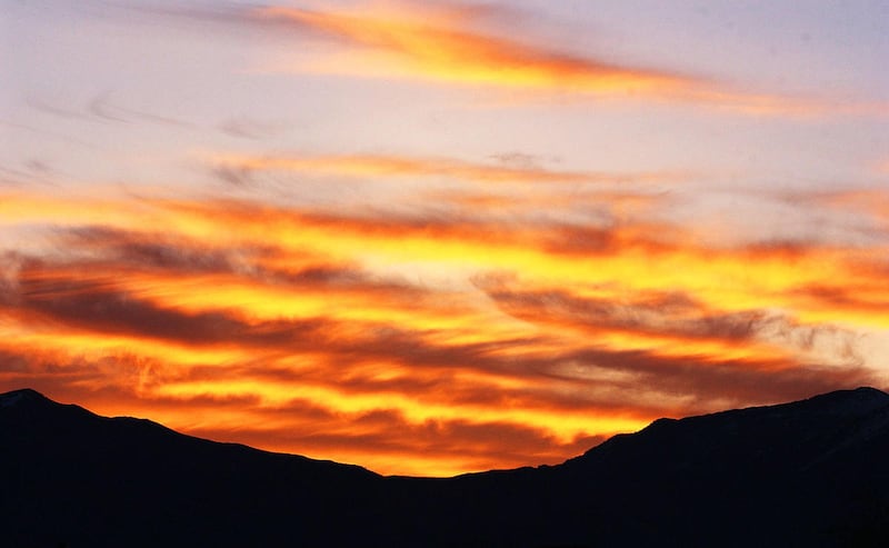 The sun rises over the Wasatch Mountains in April 2002.