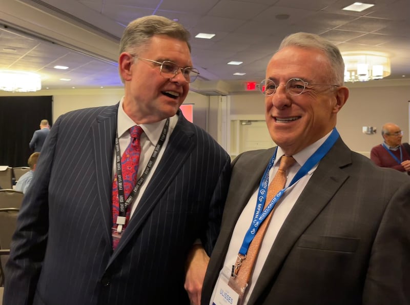 Elder Ulisses Soares and Baptis Pastor Bob Roberts link arms at the Global Faith Forum in Washington on Feb. 3, 2025.