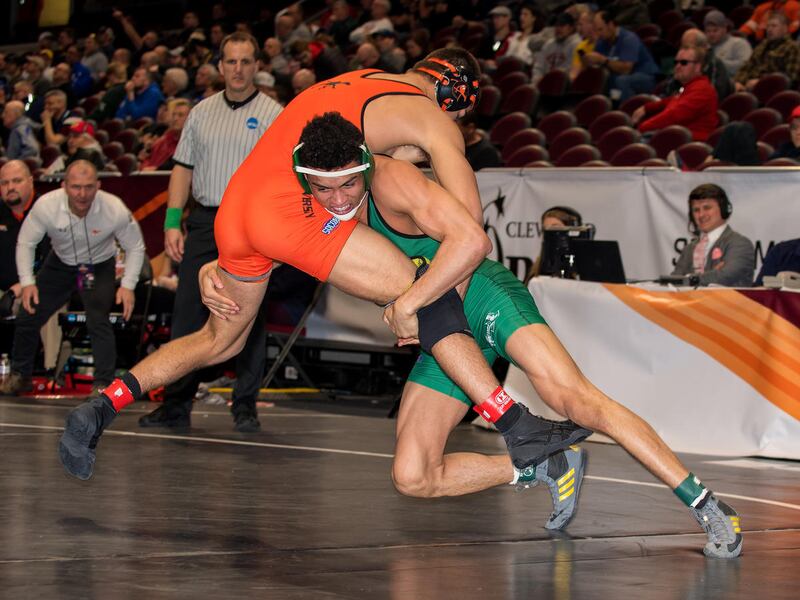 Utah Valley 165-pound sophomore Demetrius Romero (right) looks to take his opponent down to the mat at the 2018 NCAA Wrestling Championships in Cleveland last month. On Friday, Romero was one of four Wolverines to be named to the NWCA Individual All-Acade