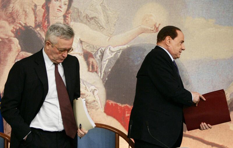 Italian Premier Silvio Berlusconi, right, and Finance Minister Giulio Tremonti leave at the end of a press conference, in Rome, Friday, Aug. 12, 2011. Italy's government has approved €45 billion ($64.12 billion) in cuts over the next two years to balanc